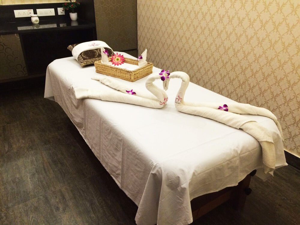 Spa treatment room with a massage bed at UVA Meridian