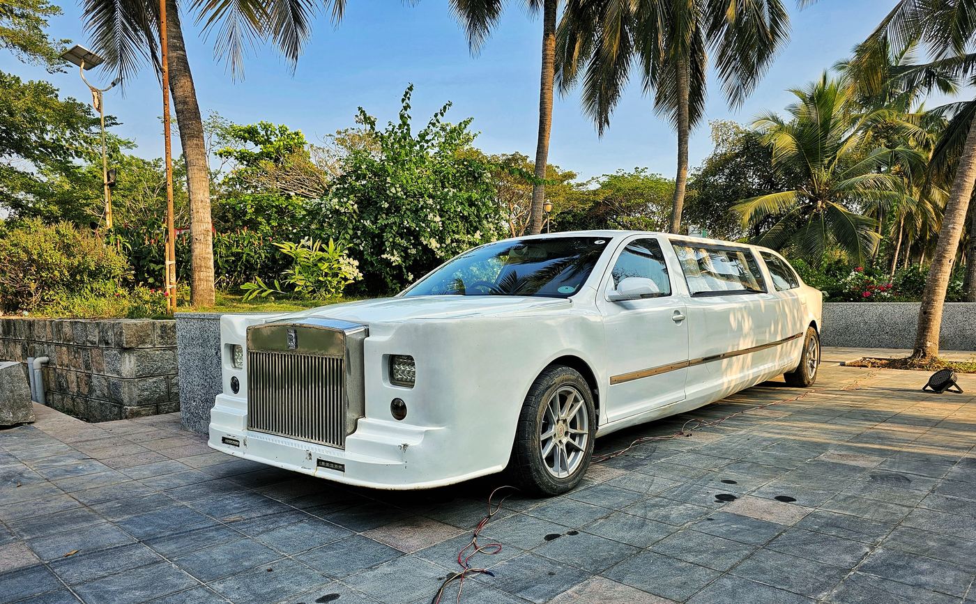 Custom-built white stretch car for the couple’s entry, among palm trees at UVA Meridian