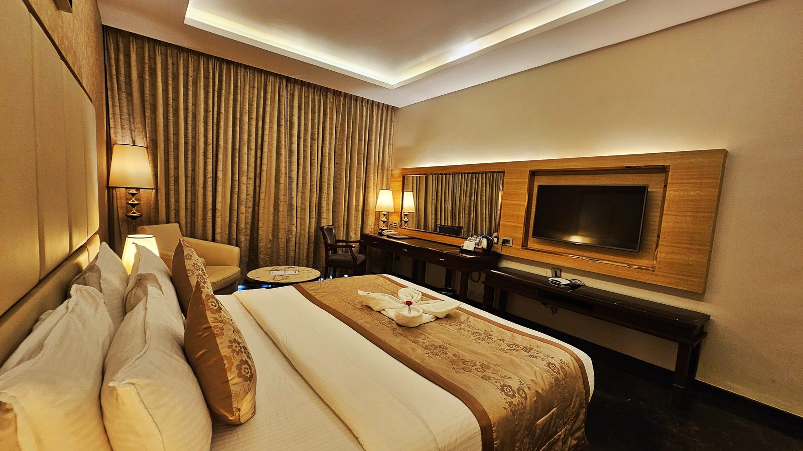 Deluxe Room bed with TV wall at UVA Meridian